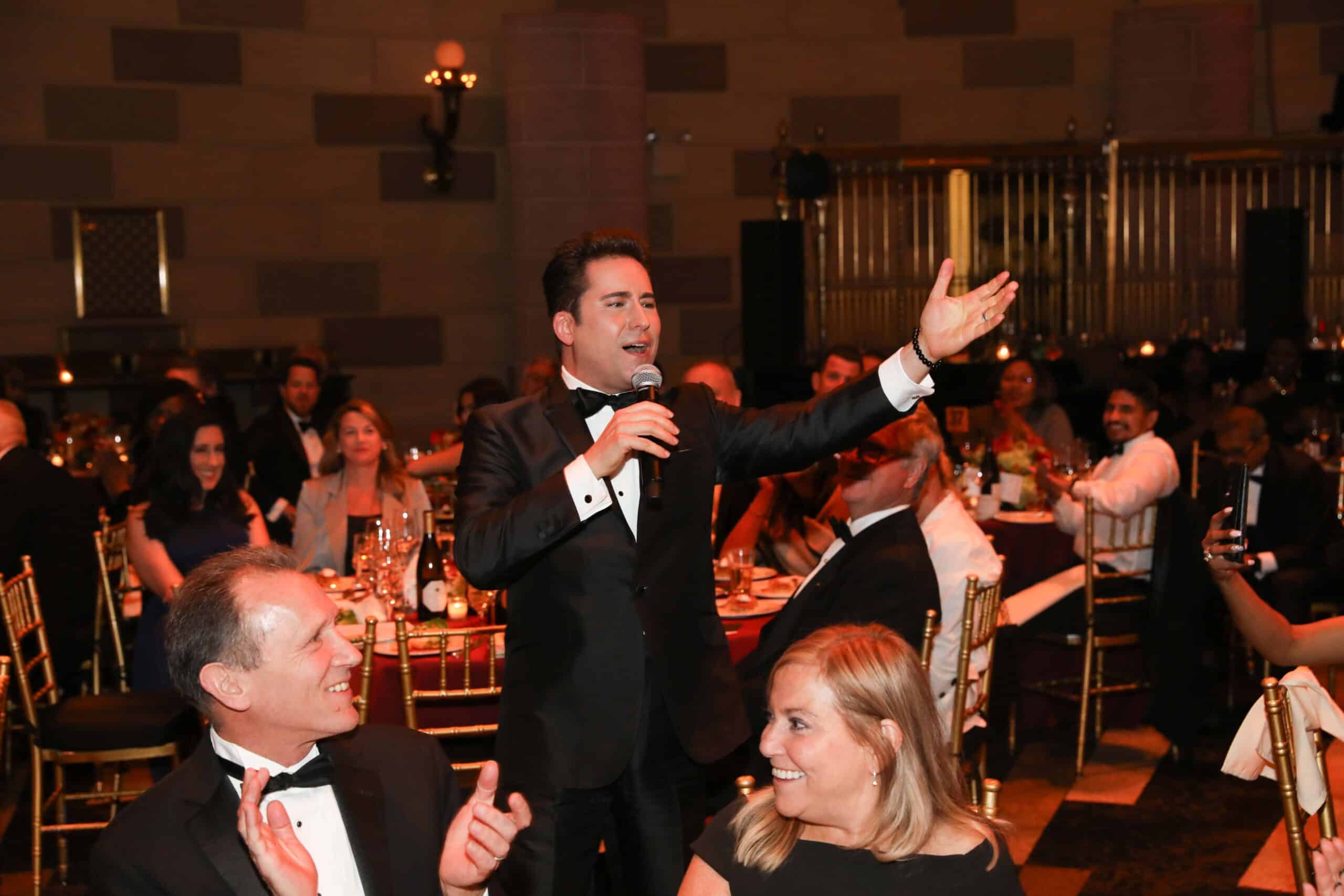 Tony award winner John Lloyd Young singing to crowd at ArchCare annual gala